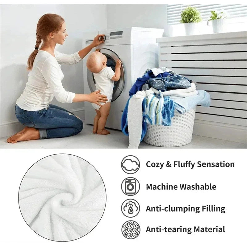 A woman kneels by a front-loading washing machine, folding a Luxurious Artificial Cashmere Weighted Blanket for Ultimate Winter Comfort as a baby stands nearby. The laundry basket overflows with clothes. Icons highlight features: tasty sensation, machine washable, anti-clumping filling, anti-tearing material.