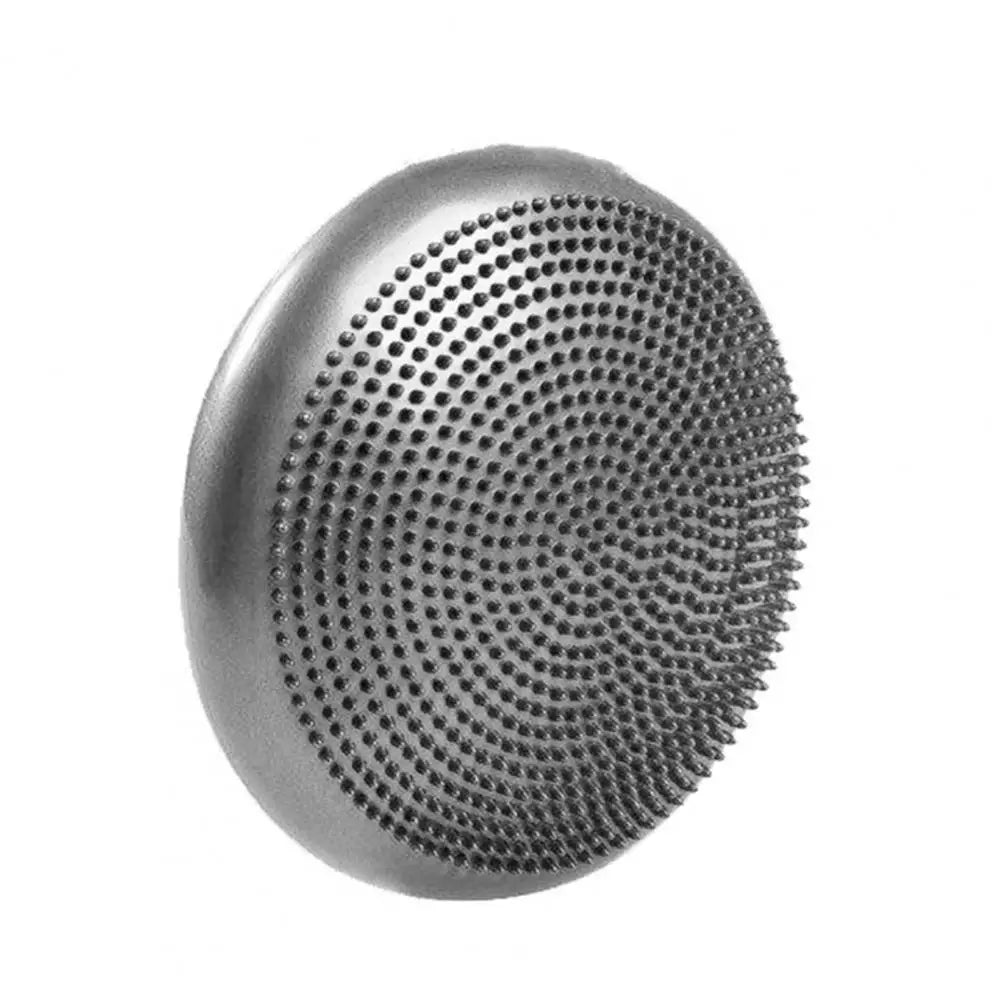 A round metal massage tool, similar to a non-slip balance training mat, features a flat surface with small spikes arranged in concentric circles. Ideal for therapeutic exercises and core strength enhancement in yoga. Background is plain white.