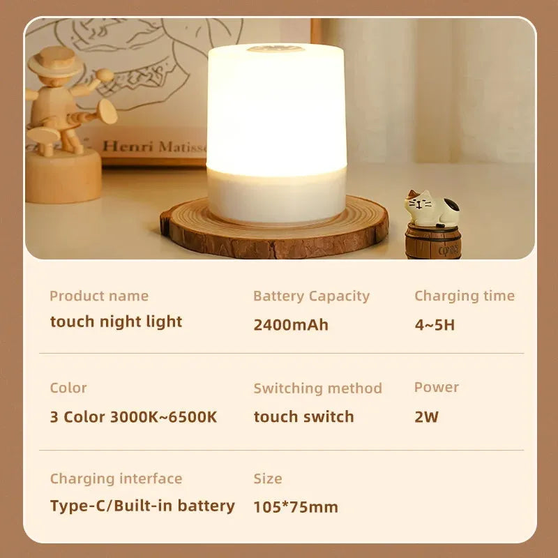 A rechargeable dimmable touch LED night light on a wooden base, featuring a small cat figurine, sits on the table. It includes USB rechargeable battery, charging time, colors, dimmable switch method, power details, charging interface, and size. Perfect for bedroom decor and as a Christmas gift for kids.