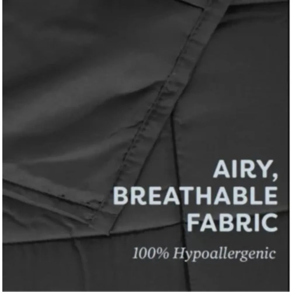 Close-up of the Plush 20lb Soft Weighted Blanket, highlighting its smooth black fabric with a slightly open fold. Text on image: Airy, breathable fabric, 100% hypoallergenic, Proudly crafted in the US, showcasing its soothing and relaxing qualities for home comfort. Free delivery included.