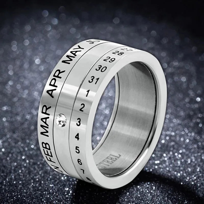 The Stainless Steel Anxiety Ring for Men and Women features rotating bands that display months, dates, and days. Its glittery dark background enhances the metallic shine, making this anti-stress fidget spinner ring a stylish punk accessory.