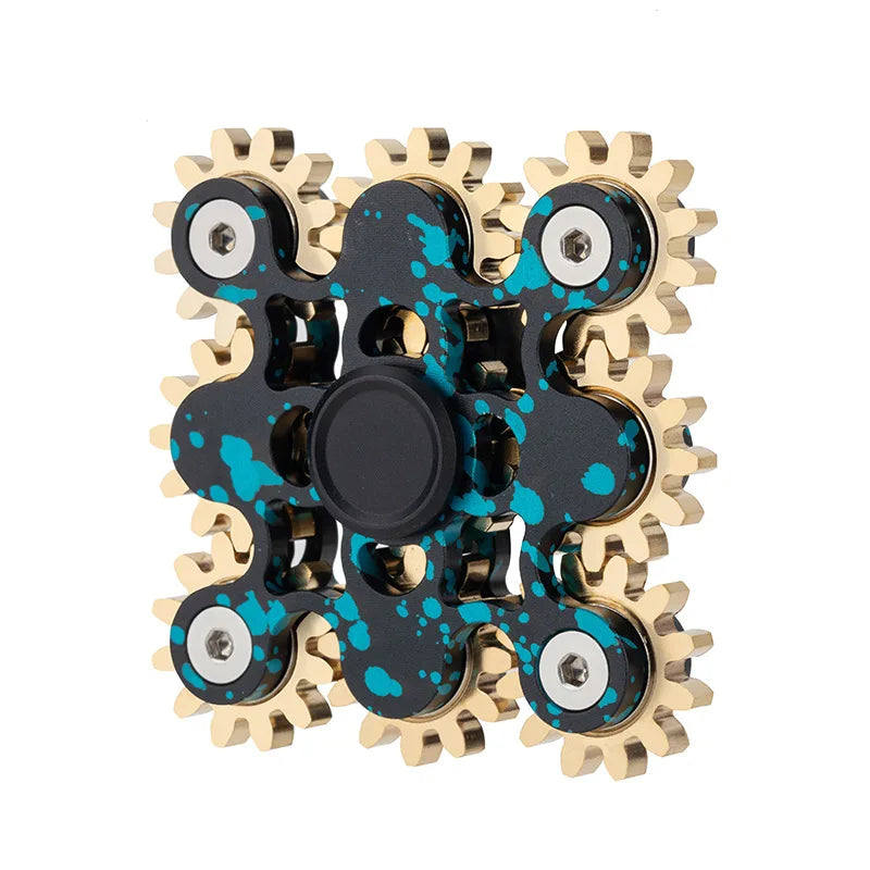 The Bike Chain Metal Fidget Spinner with Magnetic Slider offers stress relief with its square design featuring 9 interlocking gears. It showcases golden gears against a black frame with blue splatter patterns, and includes a circular black center for easy gripping. Perfect as a fun gift idea for adults.