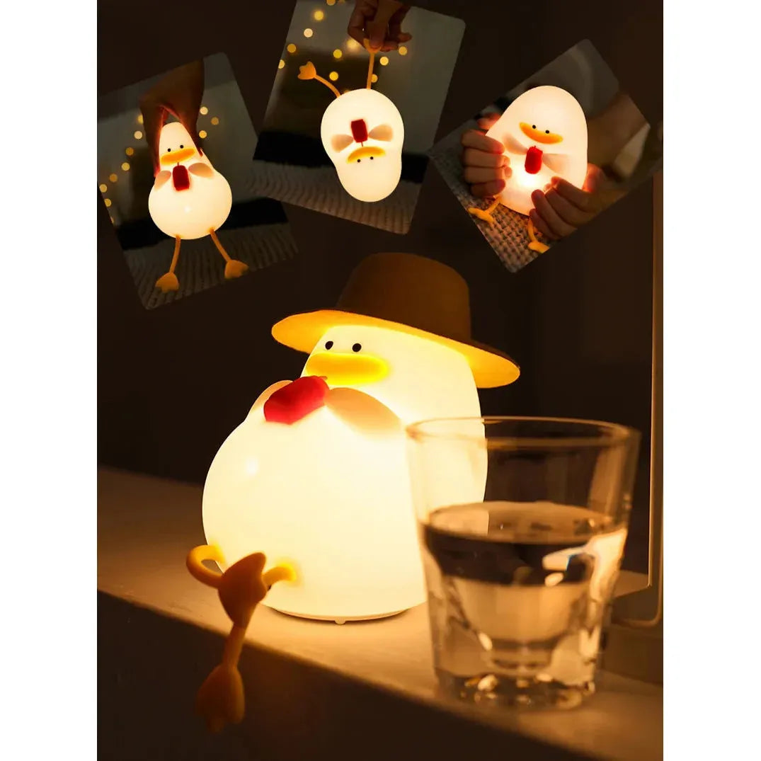 A whimsical chicken-shaped lamp wearing a hat casts a warm glow, much like the Cute Cartoon Duck Rechargeable LED Night Light. Shown on a table with water, smaller photos emphasize its charming design and portability from different angles.