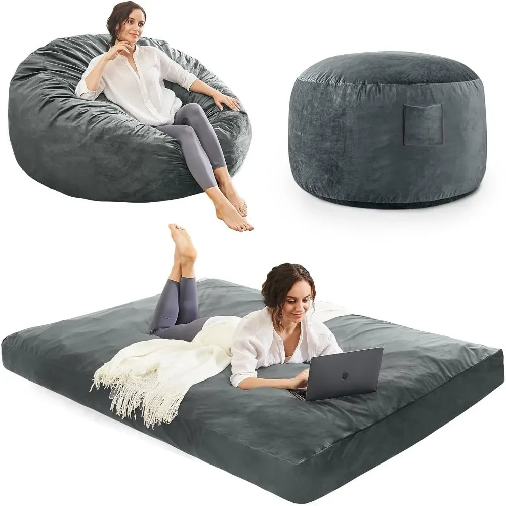 A woman relaxes on the Bean Bag Chairs Convertible Bean Bag Bed, featuring a microfiber cover and foam filler. This versatile chair transforms into an ottoman or flat mattress, offering comfort as she lounges and uses her laptop.