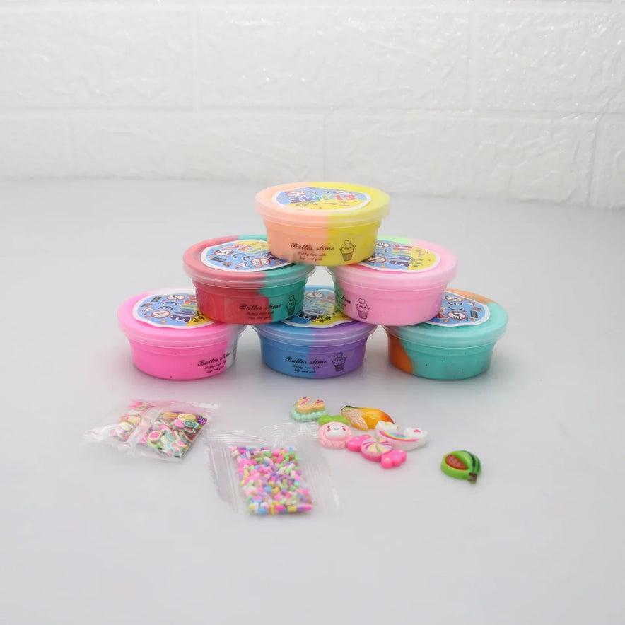 A stack of colorful slime containers, including pink, purple, and yellow, against a light background. The Slime Fluffy Kit for Enfant features miniature charms and sprinkles for decoration—a perfect DIY set that’s safe and non-toxic for all ages.