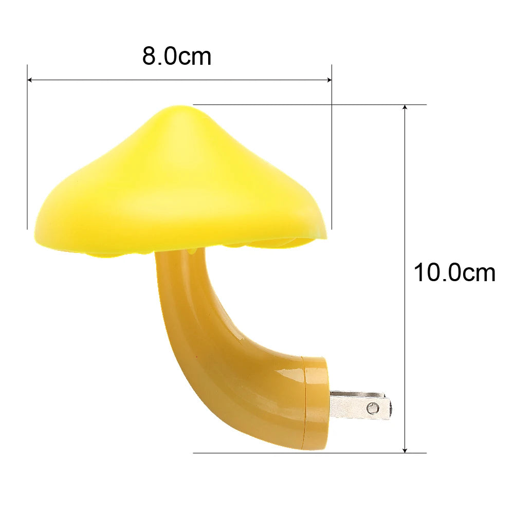 The Mushroom LED Night Light with Sensor Control, featuring a yellow cap and brown stem, emits warm white light when plugged in. It measures 8.0 cm wide by 10.0 cm tall and has a light-control sensor.