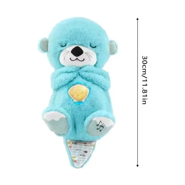 The 30cm Musical Breathing Otter Plush Toy features a smiling face, closed eyes, and a musical note on its foot. It holds a heart on its belly, has a colorful speckled tail, and combines light and sound for newborn comfort and sensory play.