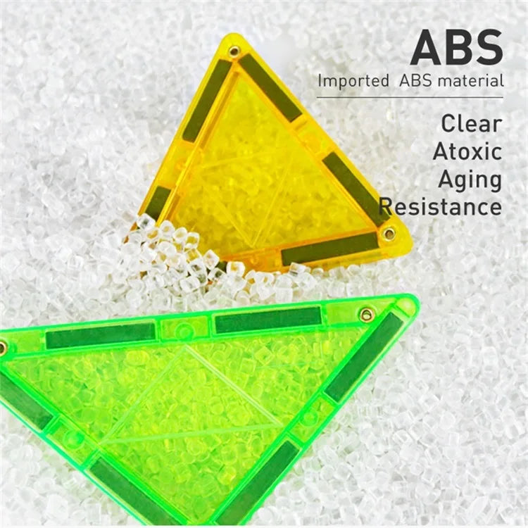 Two triangular plastic pieces, one yellow and one green, rest among small clear beads. Text reads, ABS Imported ABS material, Clear, Atoxic, Aging Resistance. Ideal for Magplayer Magnetic Construction Blocks for Kids - Educational DIY Building Set and Creative Play Tiles promoting STEM learning.