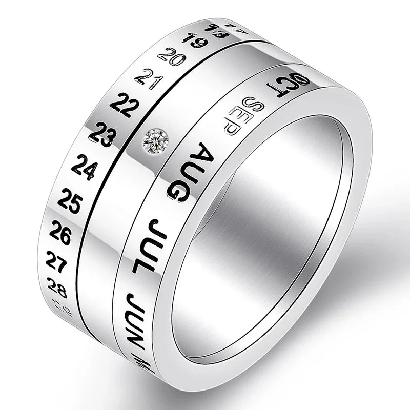 The Stainless Steel Anxiety Ring for Men and Women is a punk jewelry piece featuring black engraved numbers and months, a clear gemstone, and rotating bands to mark dates—doubling as a calendar date fidget spinner ring.