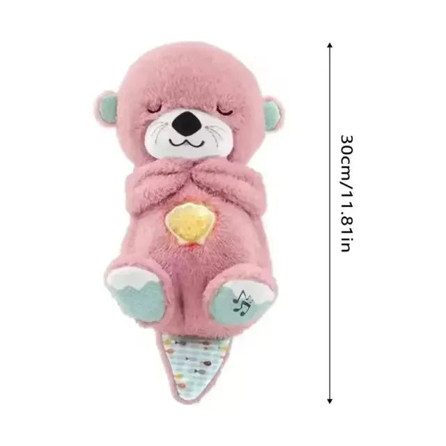 A soft pink plush otter with closed eyes, featuring a cream face, yellow heart on its belly, and a musical note on its tail. Great for newborn sensory play at 30 cm tall, it offers light and sound as the Musical Breathing Otter Plush Toy with Light and Sound for Newborn Comfort and Sensory Play.