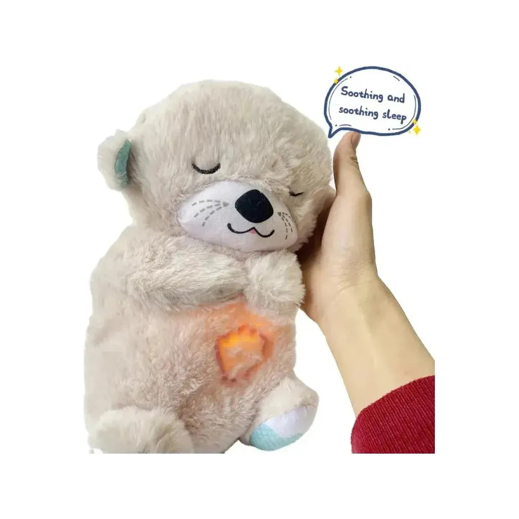 A hand holds a green otter plush with closed eyes. Its belly glows, enhancing the sensory experience. A speech bubble nearby reads Soothing and calming sleep. Introducing the Soothing Otter Musical Plush Toy with Light and Sound for Newborns - your sensory sleep companion and comfort gift.