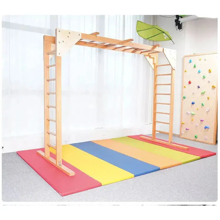 The Indoor Sensory Fitness Ladder for Kids features a wooden climbing frame with ladders, monkey bars, and a fitness ladder. It includes a small climbing wall and a colorful padded mat in red, yellow, blue, and green stripes as part of the sensory integration training equipment.