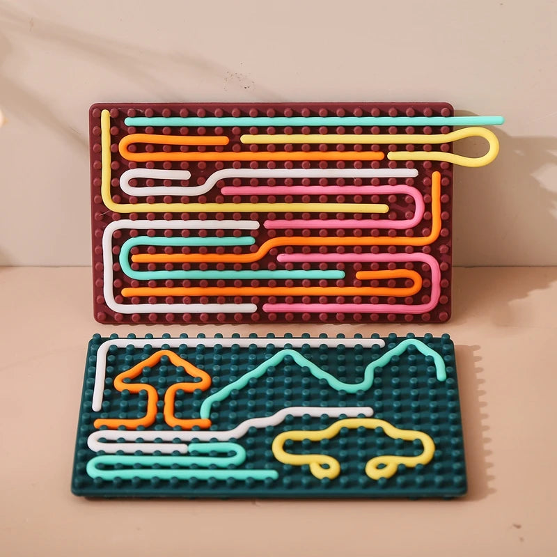 Two rectangular Silicone Montessori Sensory Activity Board Fidget Toys display colorful rods in wavy patterns, mountains, a house, and a car—perfect for kids’ creative play, anxiety relief, and mindfulness.