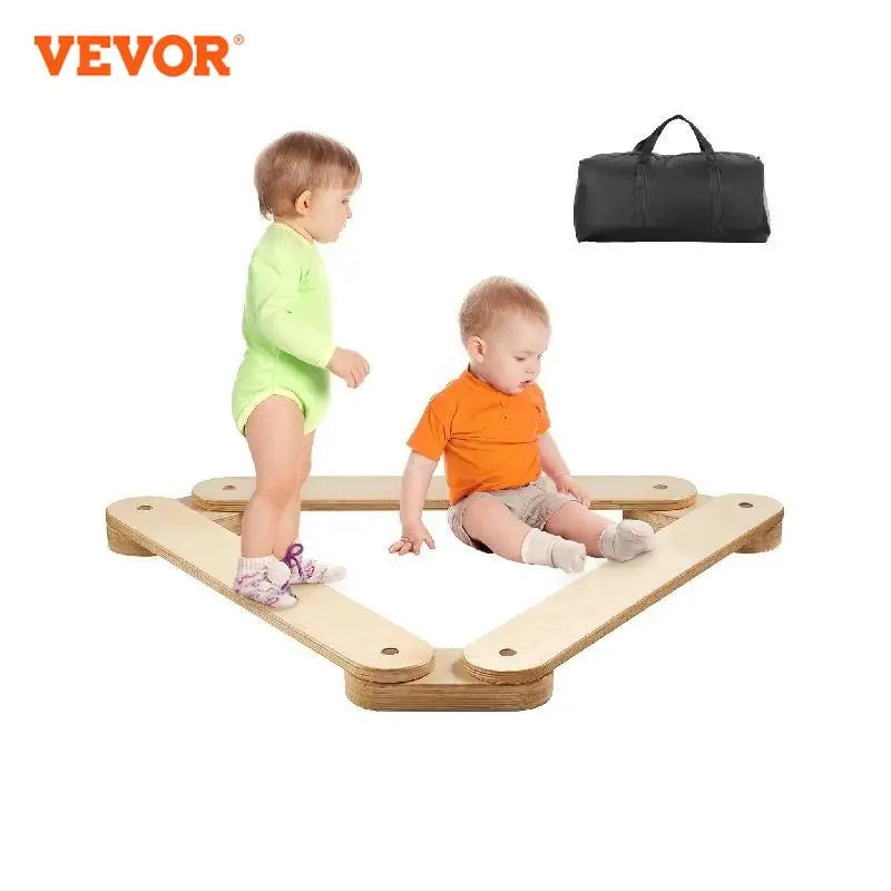 Two toddlers in green and orange outfits sit on VEVORs Wooden Toddler Balance Beam Stepping Stones, arranged triangularly, with a black carry bag above them displaying the brand VEVOR in the top left corner.