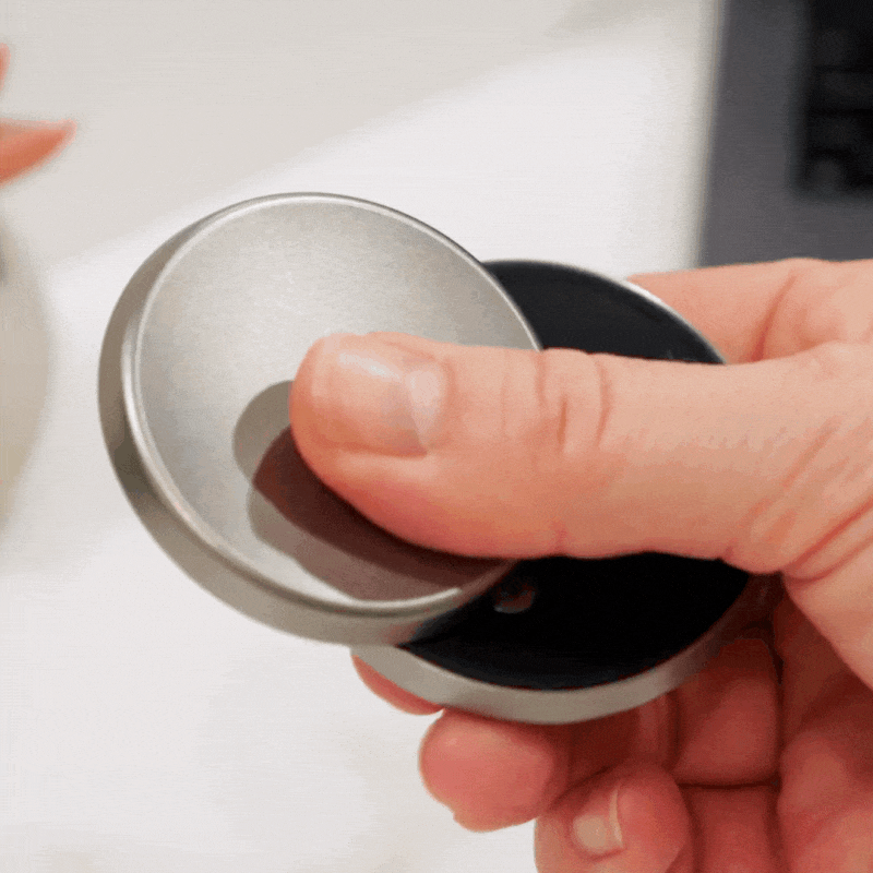 A hand slides the ONO Slider Titanium, a sleek fidget toy, smoothly back and forth, demonstrating its satisfying motion and premium titanium design.
