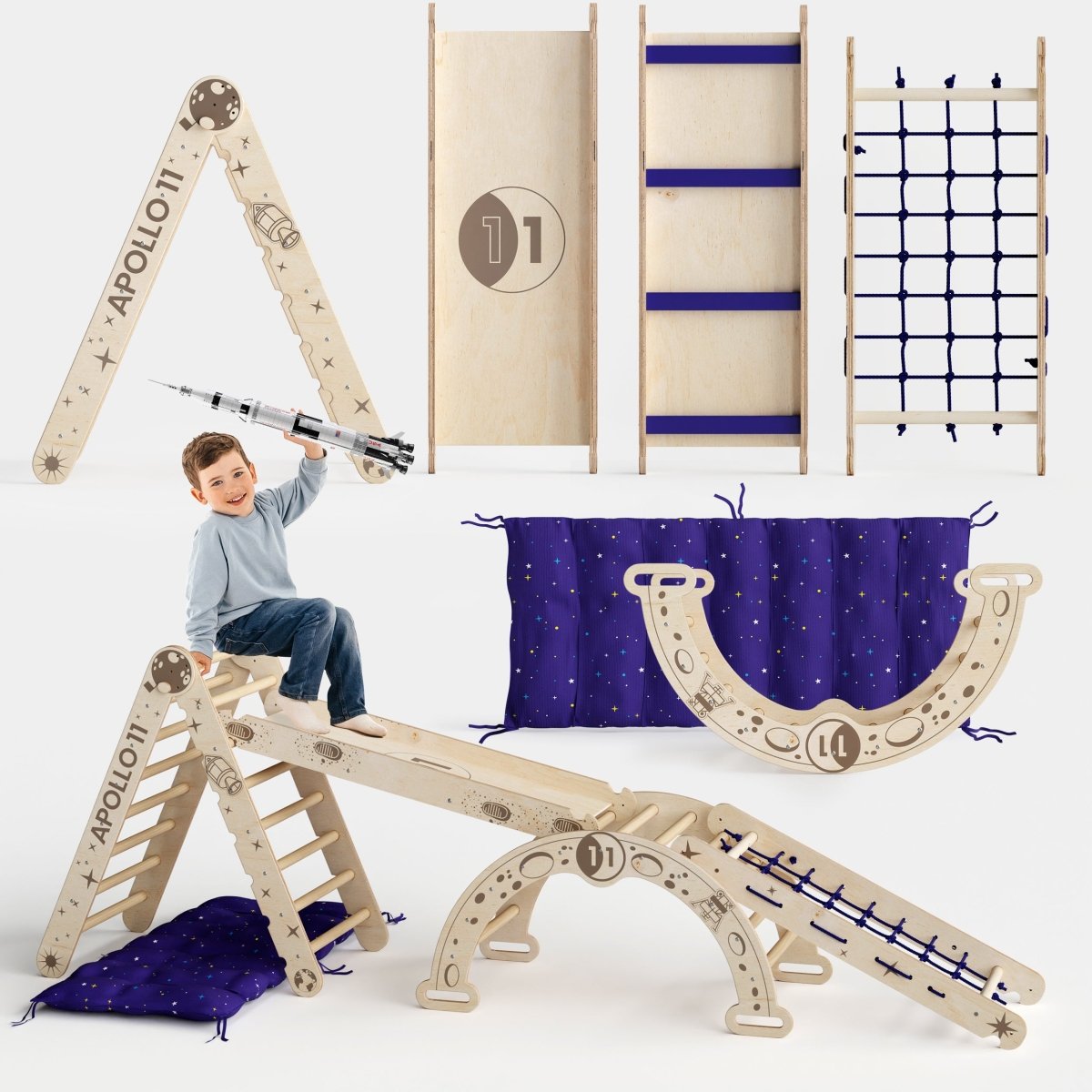 A boy plays on the Apollo 5in1 Climbing Set—a modular Pikler triangle, net, arch, slide board, and cushion for little astronauts—featuring space-themed designs, purple star-patterned mats, and a toy rocket.