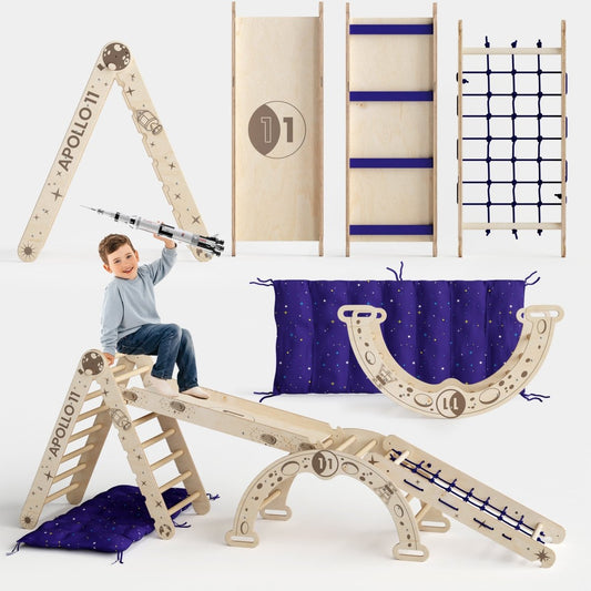A boy plays on the Apollo 5in1 Climbing Set—a modular Pikler triangle, net, arch, slide board, and cushion for little astronauts—featuring space-themed designs, purple star-patterned mats, and a toy rocket.