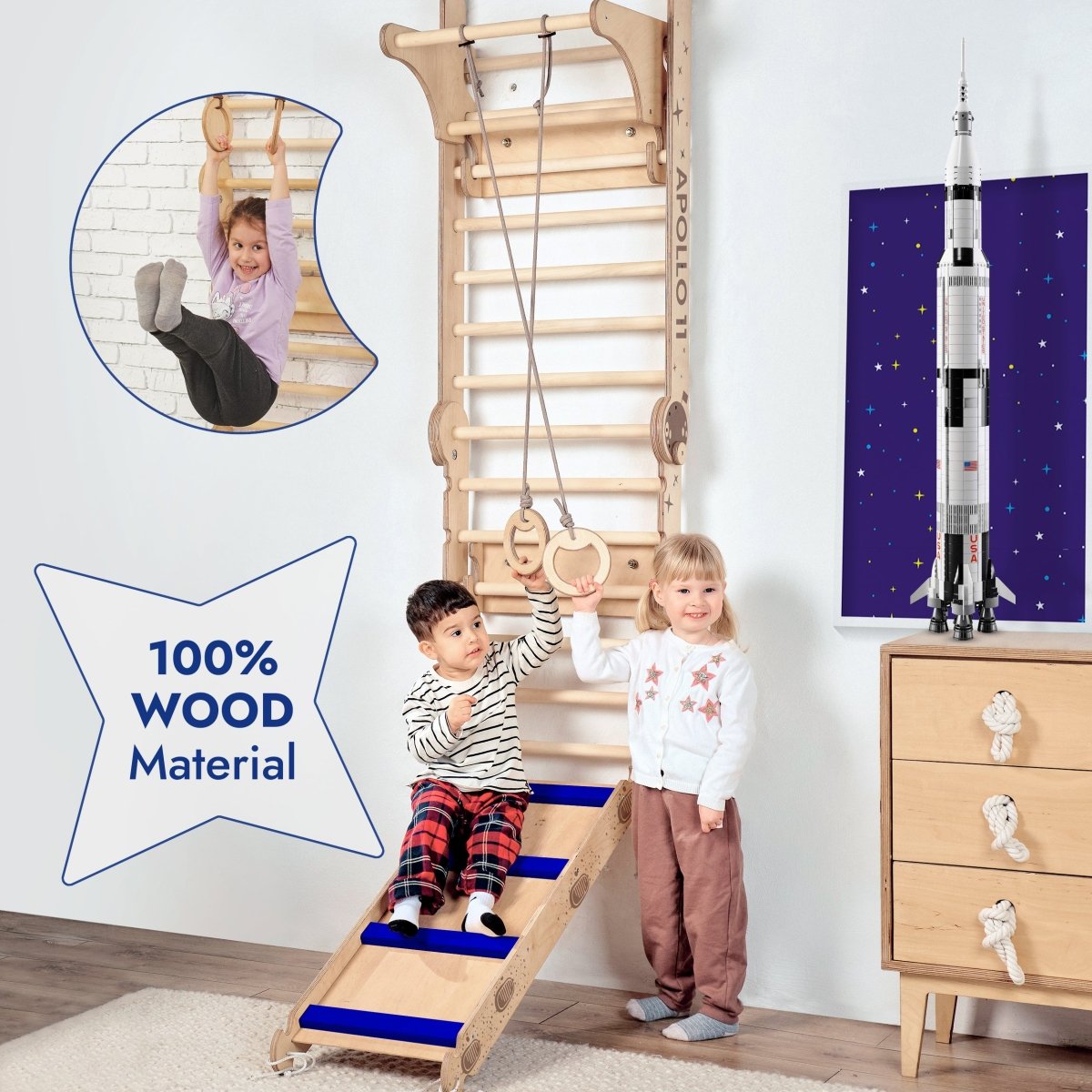 Two children play on the Apollo Swedish Wall climbing ladder for Little Astronauts, featuring a slide board and Moon swing set. A child hangs from the bars. The 100% wood space-themed playset also includes a rocket model and starry poster.