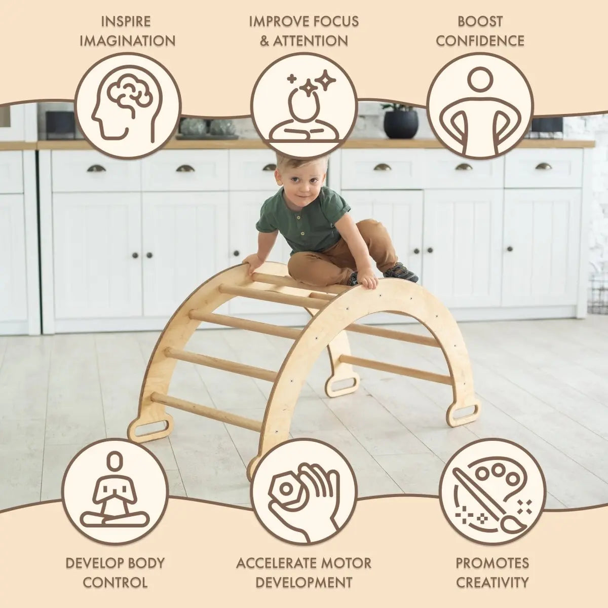 A young child climbs the Climbing Arch & Rocker Balance - Montessori Climbers for Kids 1-7 y.o. – Beige in the kitchen, with icons showing it inspires imagination, improves focus, boosts confidence, enhances control, and promotes creativity.