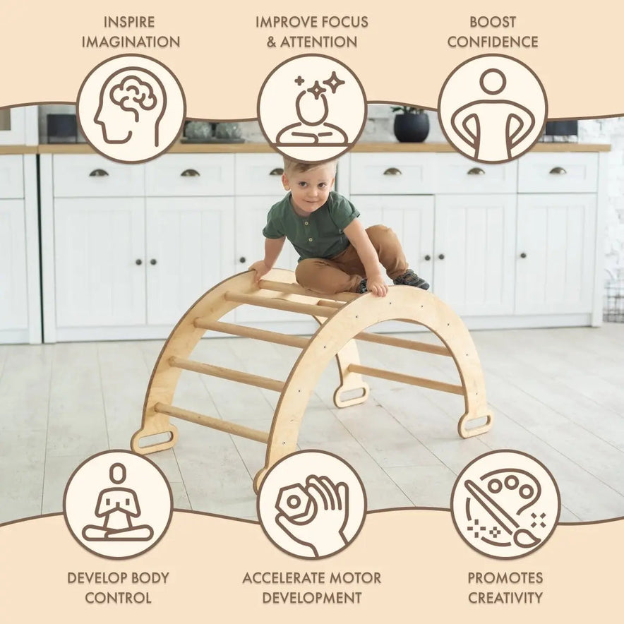 A young child climbs the Climbing Arch & Rocker Balance - Montessori Climbers for Kids 1-7 y.o. – Beige in the kitchen, with icons showing it inspires imagination, improves focus, boosts confidence, enhances control, and promotes creativity.