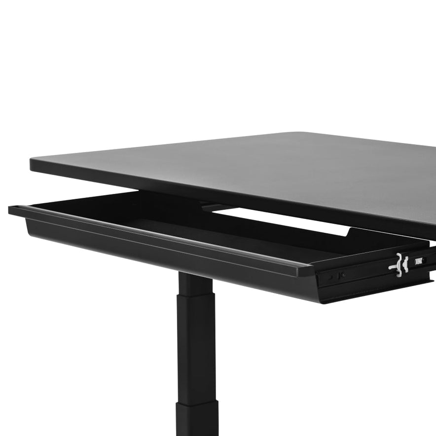 A close-up of the Under Desk Drawer shows it open beneath an adjustable-height black desk, revealing convenient under-desk storage.