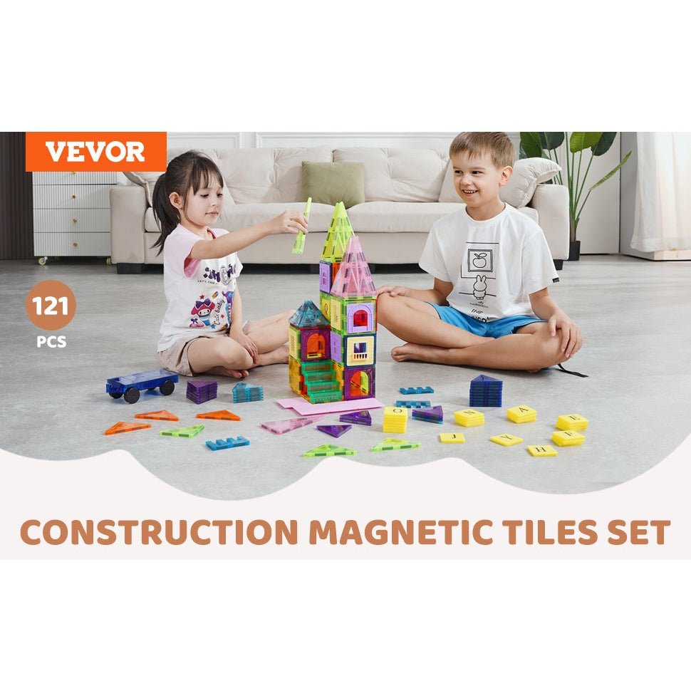 Two children play with a colorful VEVOR 121PCS Magnetic Building Blocks Set on the living room floor. The girl builds a tower as the boy watches with a smile. Text reads: VEVOR 121PCS Magnetic Building Blocks Set Construction Puzzle Montessori Toys Gifts for Children.
