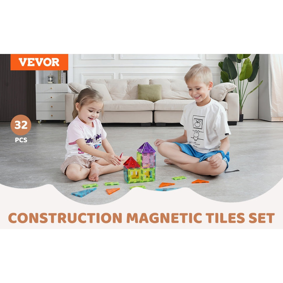 Two kids sit on the floor, smiling as they build with the VEVOR 32PCS Colorful Magnetic Building Tiles Set. The room features a sofa, plants, and light decor, with a banner displaying Vevor and STEM Educational Toy.