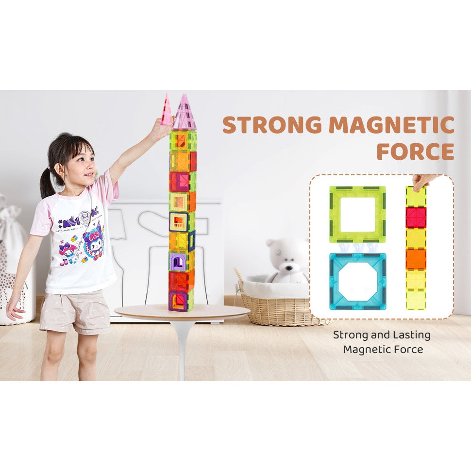 A child builds a tall tower with the VEVOR 121PCS Magnetic Building Blocks Set. Text reads Strong Magnetic Force, with squares showing the connection, while a teddy bear sits in a basket nearby.