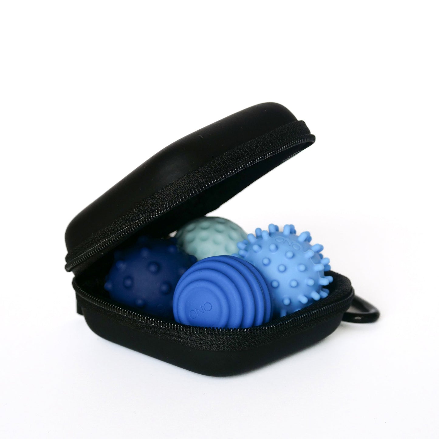 An open black zippered case displays three Sapphire-colored Signets massage balls on a white background, ideal for boosting focus or enhancing your fidgeting experience.