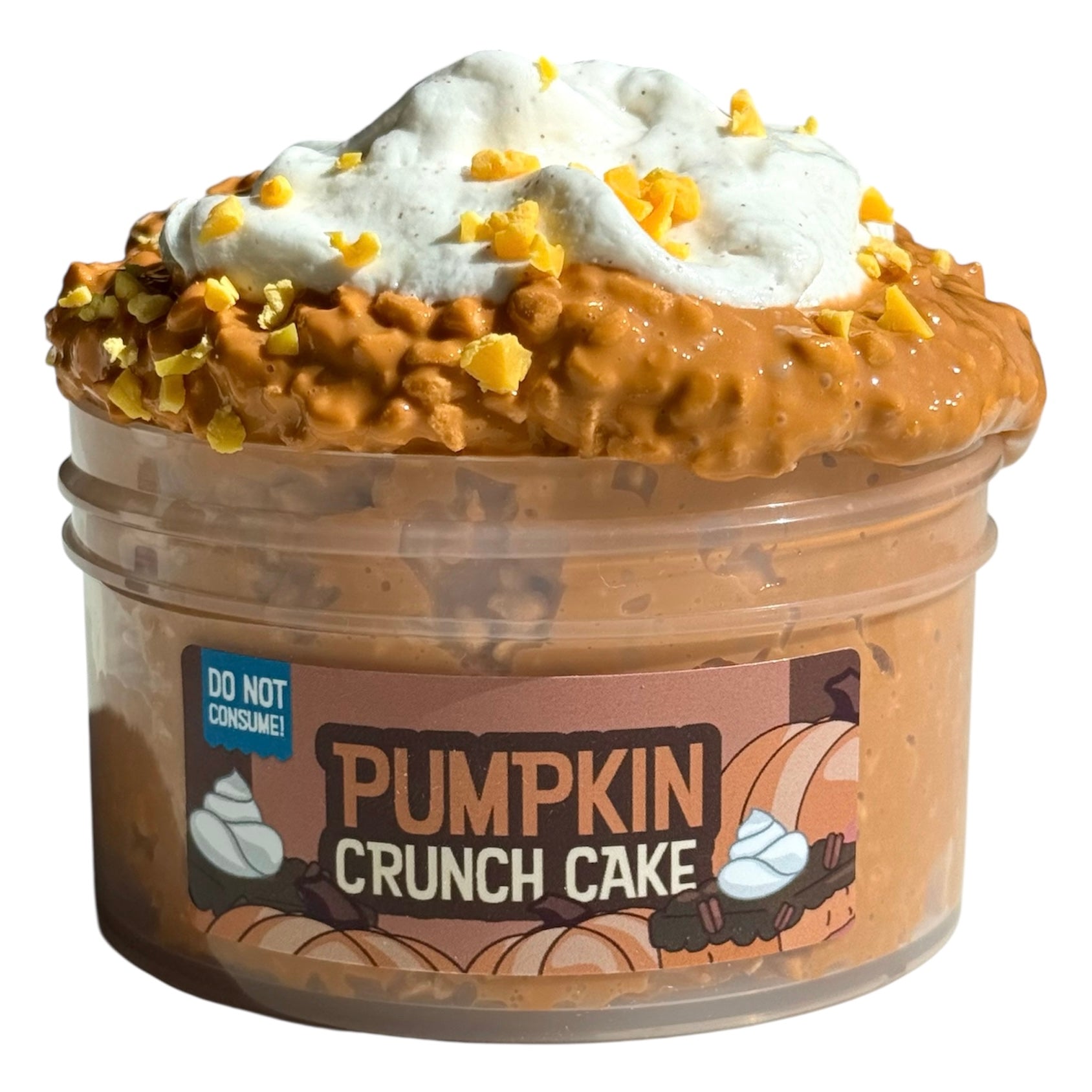 Pumpkin Crunch Cake Pumice Slime (7 oz) features creamy orange pumpkin chocolate-scented slime, frosting-like topping, yellow mix-in chunks, and a "DO NOT CONSUME!" sticker. Perfect for sensory play.
