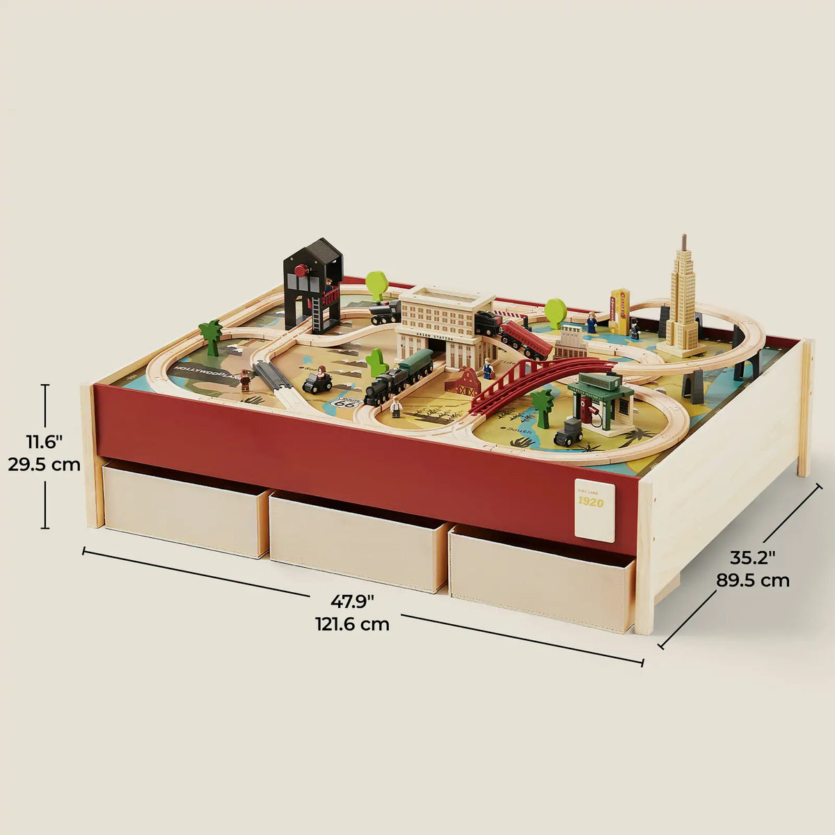 1920s Railway Wooden Train Table with Sounds featuring a built-in track, toy buildings, vehicles, and three storage drawers, set against a vintage city scene, measuring 47.9 inches wide, 35.2 inches deep, and 11.6 inches high.
