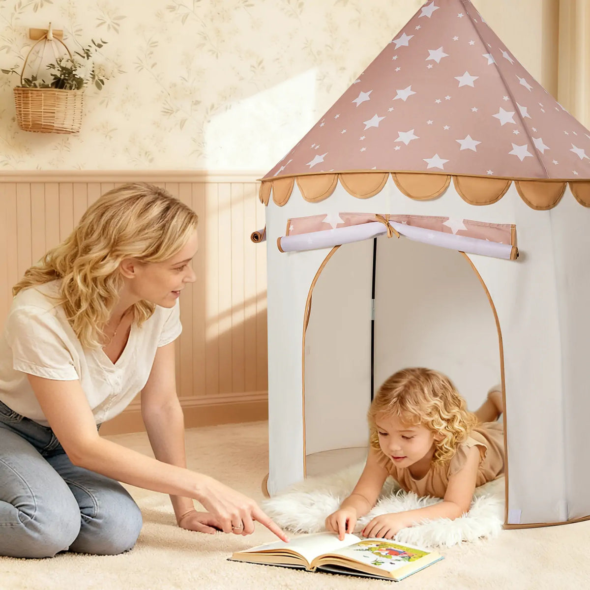A woman points to a book while a young child lies inside a Starry Indoor Play Tent for Toddlers.
