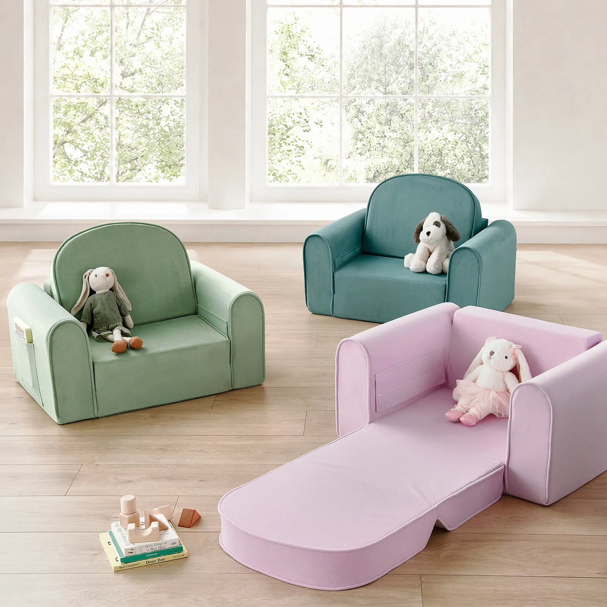 Three GentleSnug Flip-Open Kids Sofa & Nap Mat chairs in sage green, teal, and light purple, with the purple one unfolded into a nap mat, each featuring a stuffed animal on the seat.