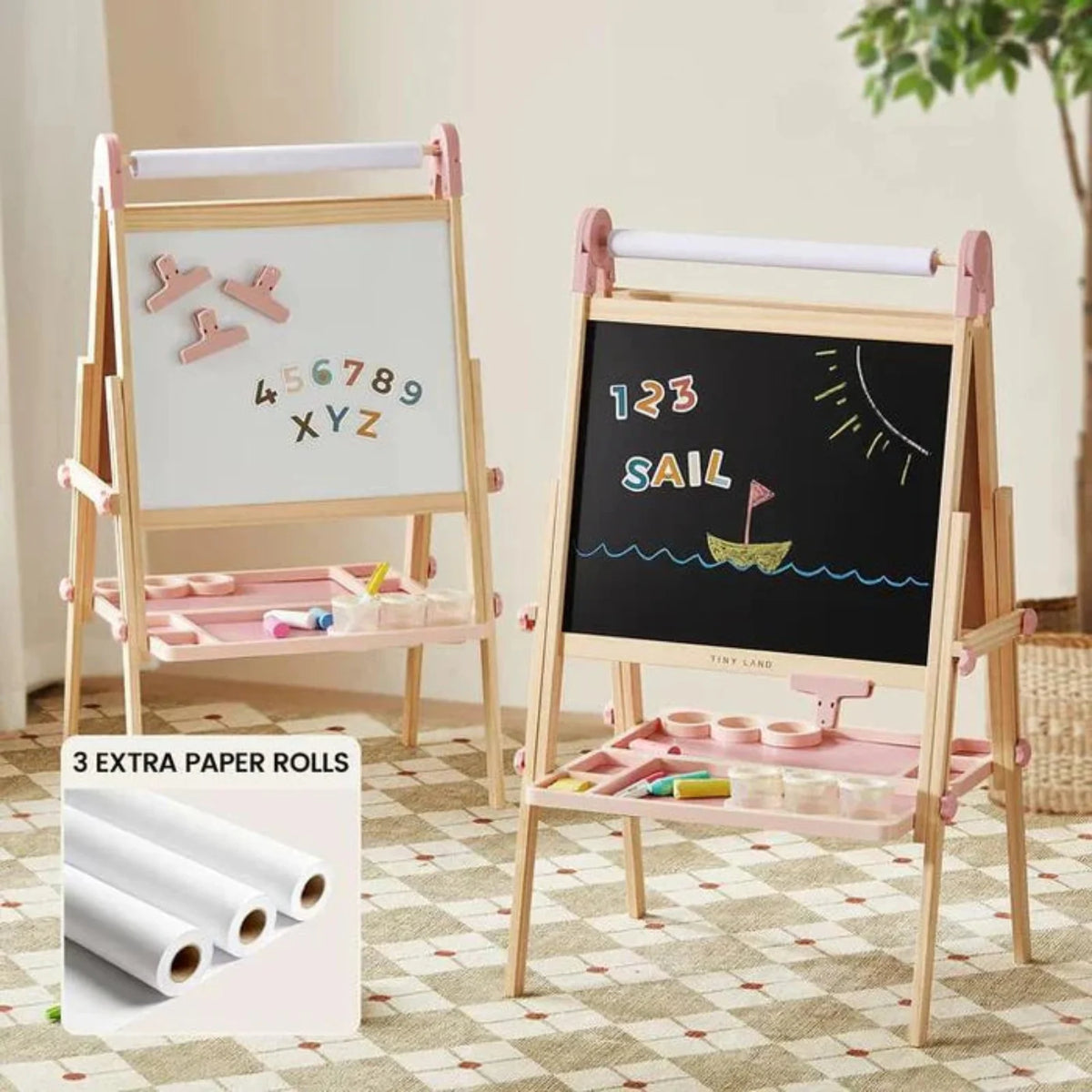 Two pink and wooden Magnitales Double-Sided Art Easel with Paper Roll units featuring a magnetic whiteboard side, a chalkboard side, and integrated storage trays, with three additional paper rolls shown in an inset.