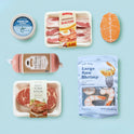 Pretend Meat & Seafood Play Pack for a pretend grill, including a can of tuna, a package of bacon, a salmon fillet, a log of sausage, a pack of beef steak, and a bag of raw shrimp for kitchen play.