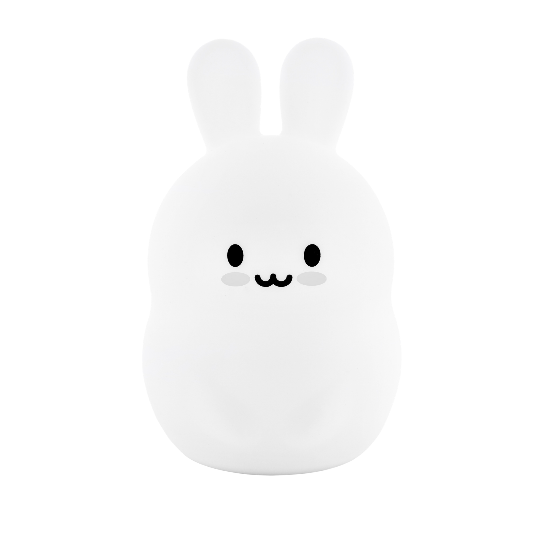 A Basil the Bunny Mini Night Light, designed as a soft silicone white rabbit with a simple, smiling face.