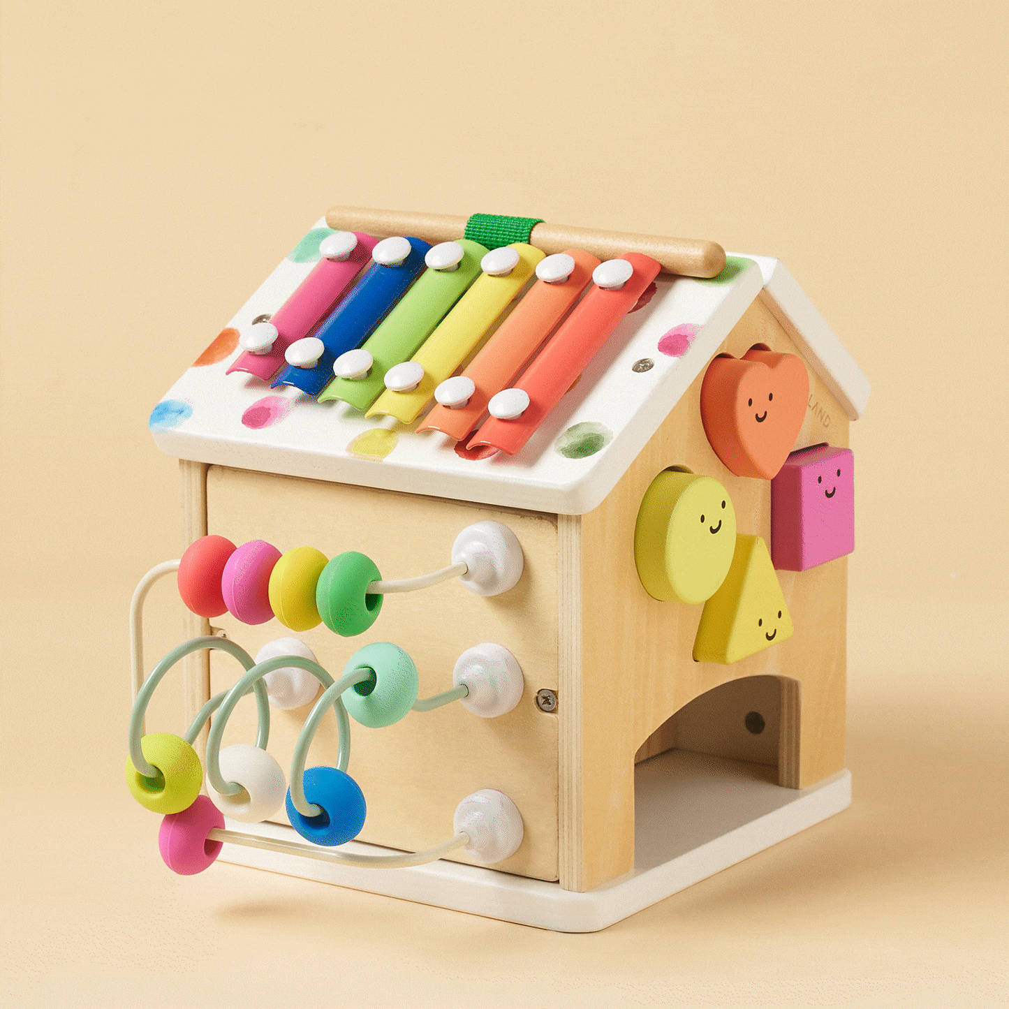 Montessori Cottage Activity Cube – Rainbow shaped like a wooden cottage, featuring a xylophone roof, a side bead maze, and colorful geometric shape-sorting pieces to build fine motor skills.