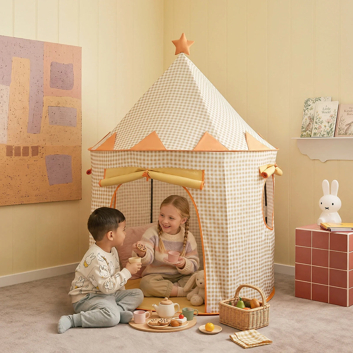 Two children play with a wooden tea set inside a Starry Indoor Play Tent for Toddlers, which is a checkered clubhouse topped with a star.
