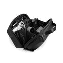 The Tech Pouch, a black organizer with multiple compartments, is open to reveal neatly arranged electronic accessories such as charging cables, adapters, and a charger for easy access while traveling.