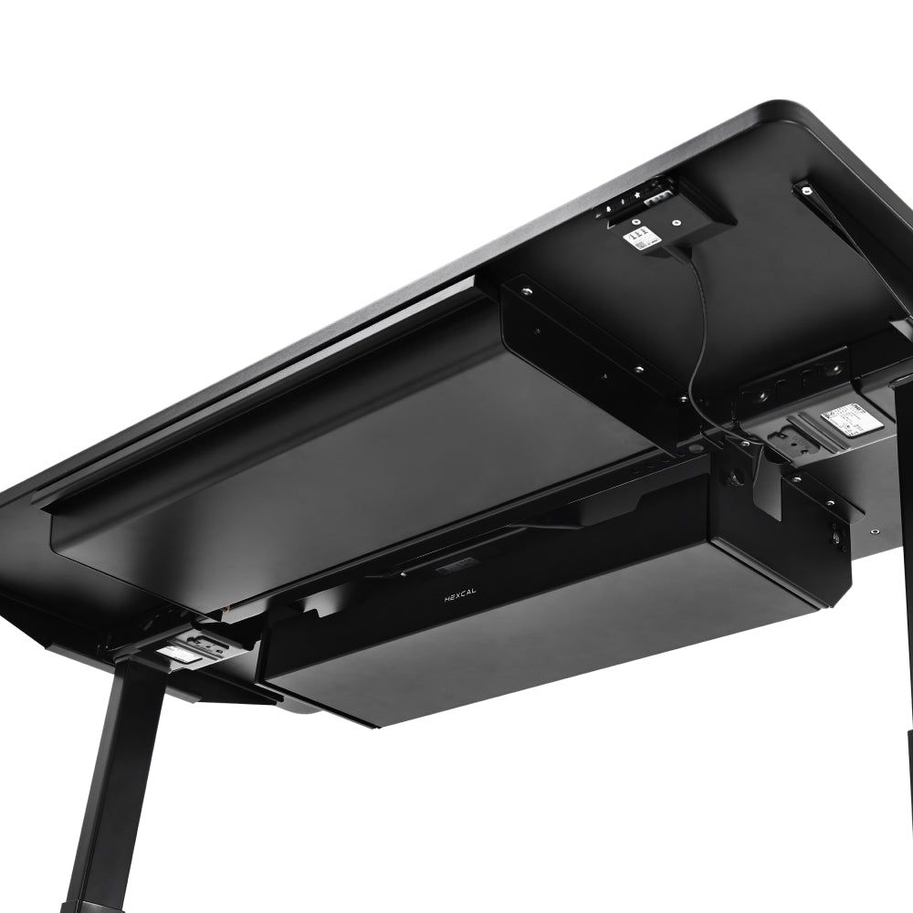 Underside view of a black standing desk showcasing an installed Under Desk Cable Management Tray, under-desk drawer, and power strip with organized cords for optimal workspace tidiness.