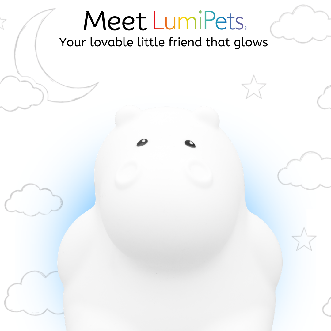 Honey the Hippo Silicone Night Light glows white against a background of cartoon clouds, stars, and a crescent moon.