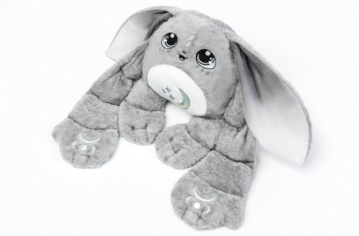 Gamma the Moon Pal – 5 lb Weighted Plush is a grey weighted rabbit with long drooping ears, large expressive eyes, and crescent moon symbols on its belly and feet, perfect as a calming hug pillow.