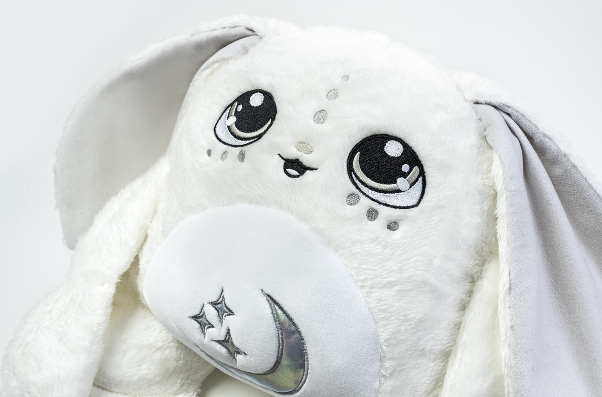 Snowball the Moon Pal – 5 lb Weighted Plush is a white plush rabbit with large embroidered eyes, floppy ears, and a crescent moon and stars patch on its belly, serving as a perfect snuggle buddy.