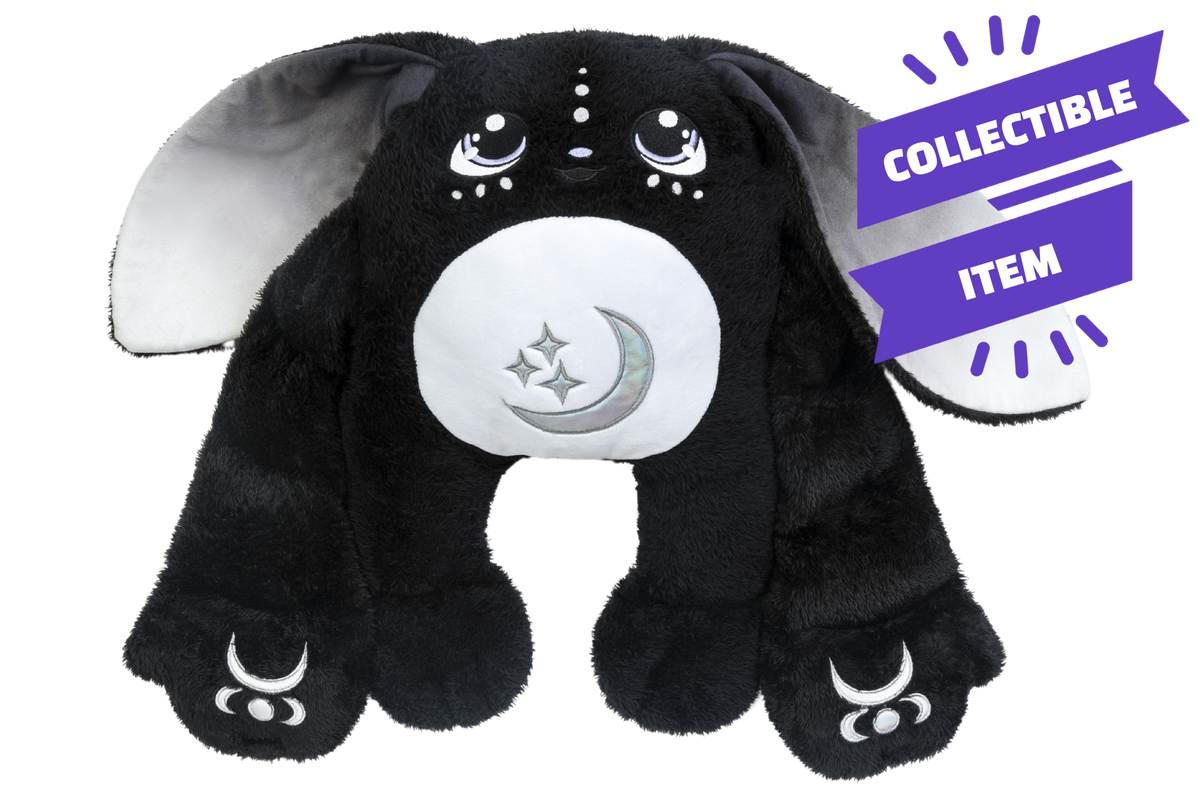Midnight Moon Pal – Collector’s 5 lb Weighted Plush is a black rabbit with long gray-lined ears, a white belly patch featuring a moon and stars, and crescent moon symbols on its feet, with a purple collector’s edition banner in the top right.