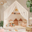 A Large Cozy Cabin Play Tent with Star Lights featuring sheer curtains, two mouse dolls, house-shaped pillows, and a heart-shaped pillow on a plush rug.