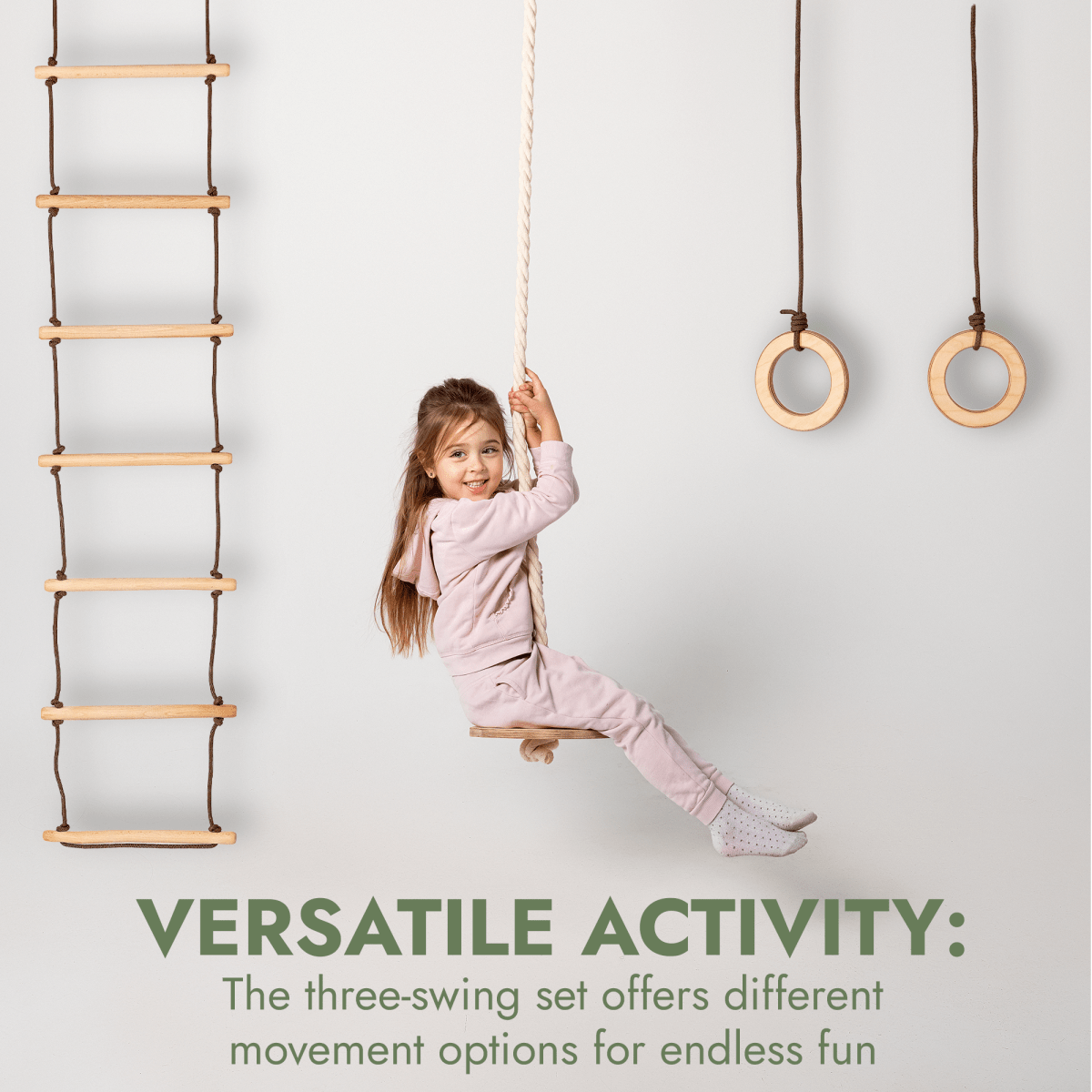 A smiling young girl in a pink sweatsuit swings on the disc swing, part of the 3in1 Swing & Climbing Set featuring a wooden rope ladder and two gymnastic rings. Text below reads: Versatile Activity: The 3in1 Swing & Climbing Set encourages child development by providing multiple movement options for endless fun.