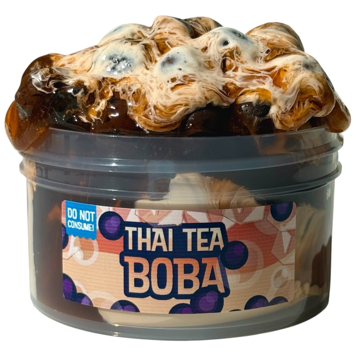 The Thai Tea Boba Slime Avalanche is a 7 oz clear pebble slime scented like condensed milk, featuring boba pearls and syrup kit, in a plastic container labeled with a “DO NOT CONSUME!” sticker—ideal for ASMR slime lovers.