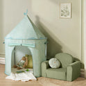 A light green floral Starry Indoor Play Tent for Toddlers with a stuffed bunny inside next to a small green armchair.