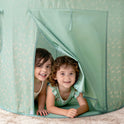Two smiling children peeking out from the opening of a floral-patterned Starry Indoor Play Tent for Toddlers.