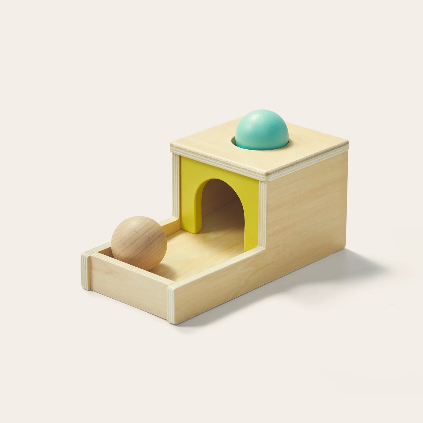 The Tiny Land® Montessori Toys for Newborns (7–9 Months) features a wooden Object Permanence Box with a yellow arch, sensory ball tray, and turquoise ball—perfect for helping babies develop hand-eye coordination and object permanence.